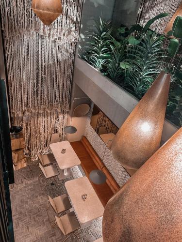 a room with chairs and vases and plants at Primavera Luxury Apartments Medellin in Medellín
