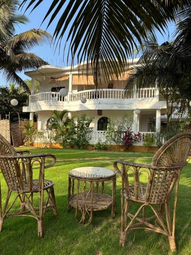 a table and chairs in front of a house at SOLS Backyard in Arambol