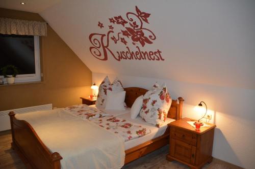 a bedroom with a bed with a sign on the wall at Ferienappartements "Landromantik" in Bautzen