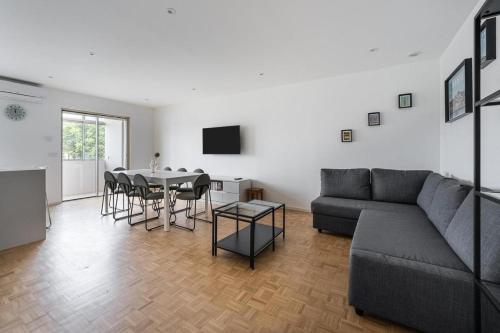 a living room with a couch and a table at Family Flat Near Porto in Rio Tinto