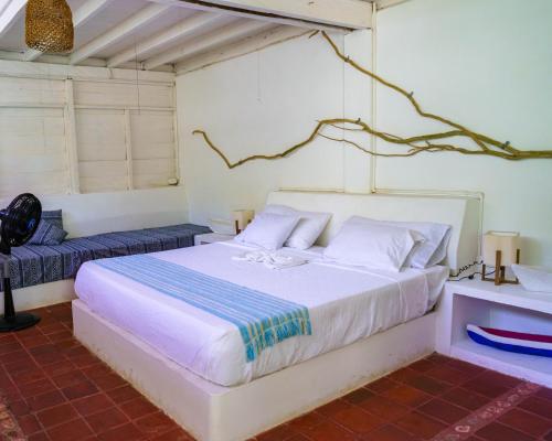 a bedroom with a large white bed in a room at Hotel Fuerte Mayal in Isla Fuerte