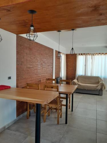 a living room with two wooden tables and a couch at Acacias in El Bolsón