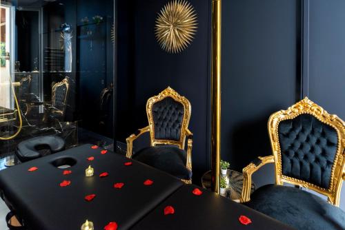 a dining room with a black table and two chairs at La Suite Tentation in Cannes