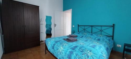 a blue bedroom with a bed with a blue blanket at La Casa di Nonna Rosa in Rome