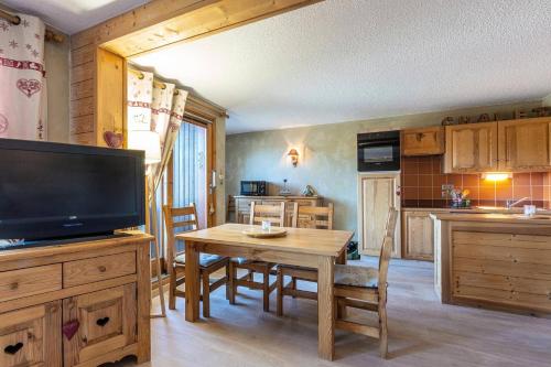 - une cuisine avec une table et une télévision dans la chambre dans l'établissement Résidence Le Damier - Appartement 3 pièces pour 6 personnes de 52m² MAE-0761, à La Plagne Tarentaise