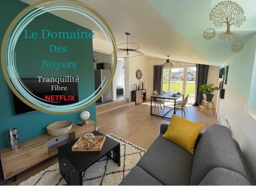 a living room with a gray couch and a large mirror at *** Domaine des Noyers - Proche centre Ville in Châteauneuf-sur-Loire