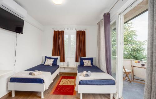 a bedroom with two beds and a tv and a balcony at Villa Ana-Marija in Imotski