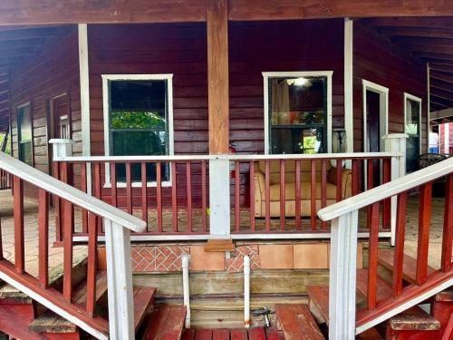 a front porch of a house with two windows at Fosters West Bay Resort in West Bay