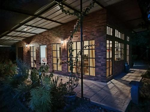 a brick building with windows and a patio at Wabi-Sabi House in Aguazul
