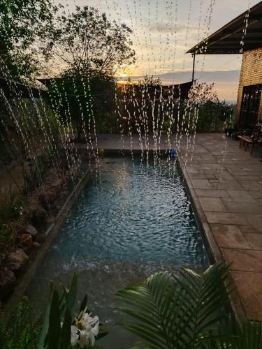 a pool with a fountain in a yard at Wabi-Sabi House in Aguazul