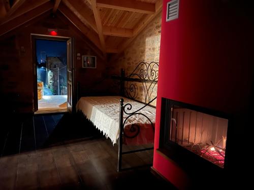 a bedroom with a fireplace and a bed in a room at Pietra Rossa in Chios