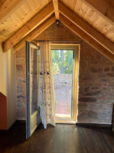 a room with a large window in a house at Pietra Rossa in Chios