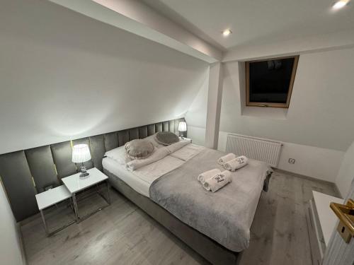 a bedroom with a bed with two towels on it at Villa Śnieżka in Kowary