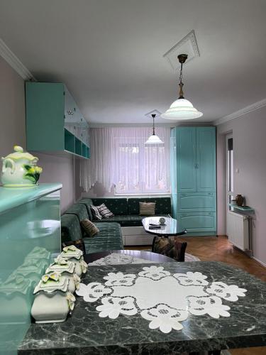 a living room with a couch and a table at Apartman Ivanka in Zlatibor