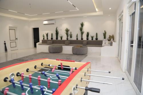 ein Wohnzimmer mit einem großen Billardtisch mit Paddeln in der Unterkunft Malina Resort منتجع مالينا in Ras al Khaimah