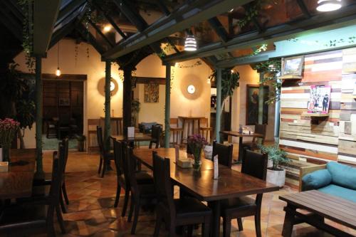 a restaurant with tables and chairs in a room at Axkan Arte Hotel in San Cristóbal de Las Casas