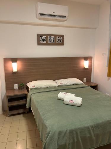 a bedroom with a bed with two towels on it at Hotel Saveiro in Recife