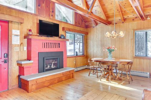 a living room with a fireplace and a dining room table at Less Than 2 Blocks to Lake Tahoe Family Home Near Skiing in Homewood