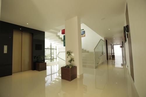 a hallway with stairs and potted plants in a building at Park Connect in Cochin