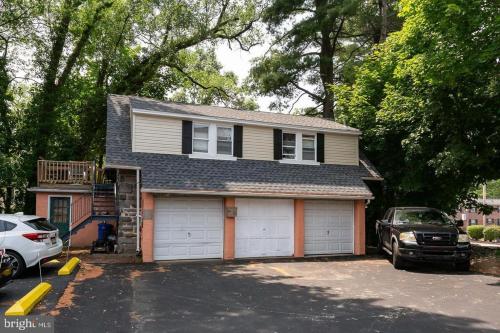 a house with a car parked in a parking lot at New! Ground-level 2b2b In Bryn Mawr W Parking!! in Bryn Mawr