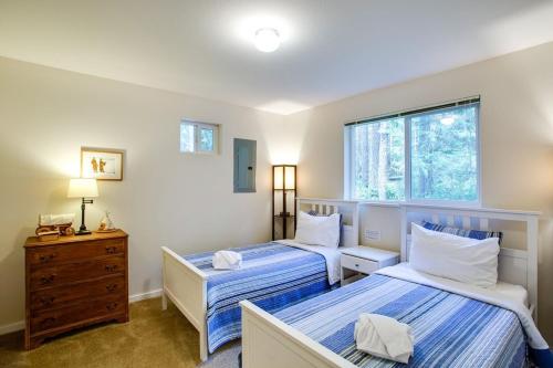 a bedroom with two beds and a window at Glacier Springs Cabin - Wood Stove, Hot Tub, WIFI, Sleeps 8 in Deming