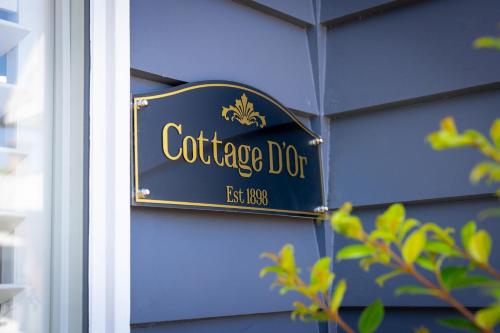 a sign on the side of a blue building at Cottage D'Or in Ballarat