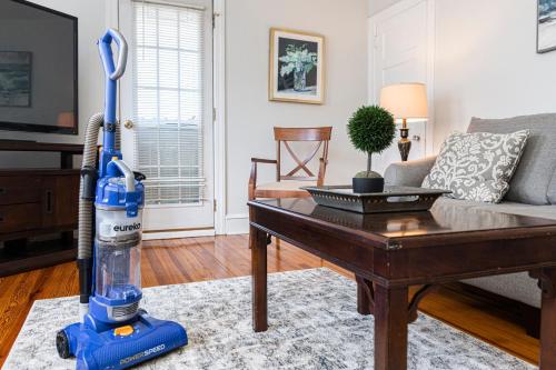 a blue vacuum cleaner in a living room with a table at Bryn Mawr Gembalconydedicated Parking50tv in Bryn Mawr