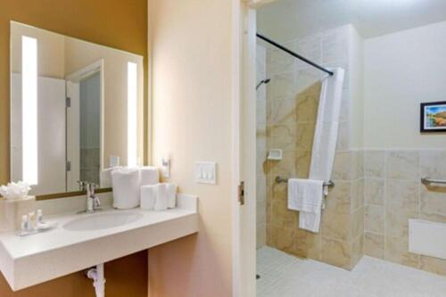 a bathroom with a sink and a shower at Comfort Inn & Suites Near Ontario Airport in Ontario