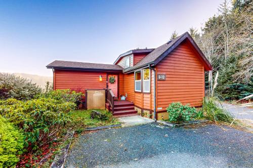 a red house with a driveway in front of it at Whaleshead Wonderland in Carpenterville