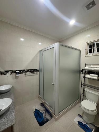 a bathroom with a shower and a toilet and a sink at Senior Suite 3 Bedroom in Beterverwagting