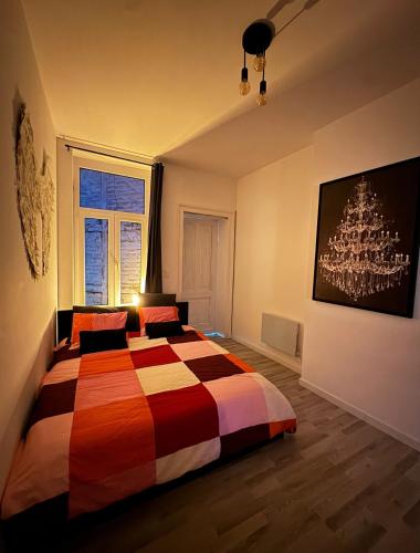 a bedroom with a bed and a chandelier at Romeo et juliette in Spa
