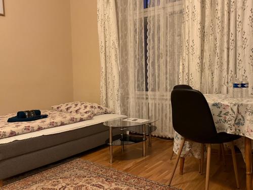 a bedroom with a bed and a table and a window at Salve Teplice in Teplice