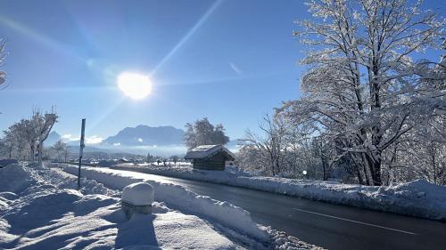 a person is walking down a snow covered road at Alpenfels Zwieselstein in Sölden