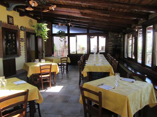 a dining room with tables and chairs with yellow table cloth at Luna D'Agerola in Agerola