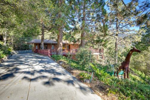 a house with a giraffe standing next to a road at Stunning Idyllwild Home with Private Hot Tub and Decks in Idyllwild