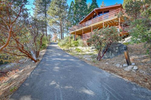 a road leading to a house in the woods at Stunning Idyllwild Home with Private Hot Tub and Decks in Idyllwild