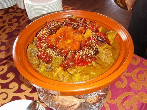 an orange bowl of food on a table at Hotel Dar Eddaya in Khemisset