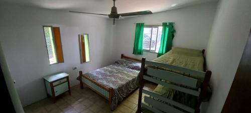 a small bedroom with a bed and a window at Casa Icho Cruz in Villa Icho Cruz