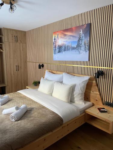 a bedroom with a large bed with white pillows at Alpenfels Zwieselstein in Sölden