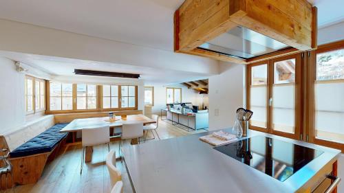 a kitchen and living room with a table and a couch at Chalet Rominger-Surlej in Surlej