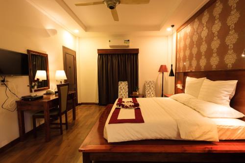 a hotel room with a bed and a desk and a computer at Phu Quoc Villa in Phu Quoc