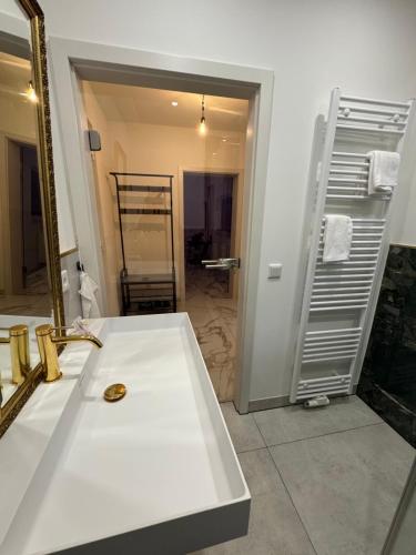 a bathroom with a white sink and a mirror at Whirlpool-Zimmer-VIP in Diez
