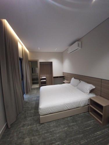 a hotel room with a white bed and a desk at فيلا هيفاء in Medina