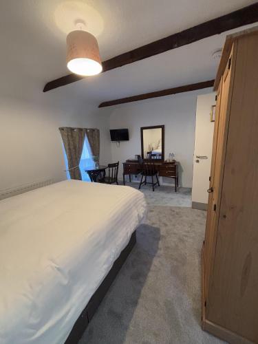 a bedroom with a large bed and a table at Yak & Yeti in Shrewsbury