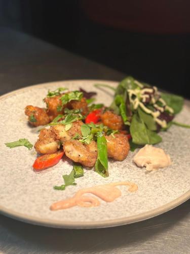 a plate of food with meat and vegetables on a table at Yak & Yeti in Shrewsbury