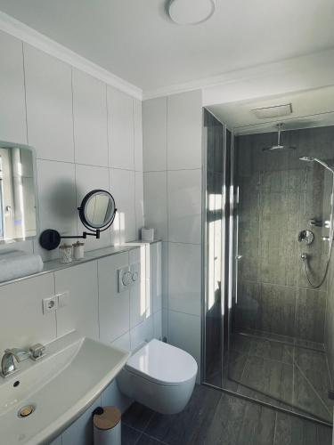 a bathroom with a shower and a toilet and a sink at Alpenfels Zwieselstein in Sölden