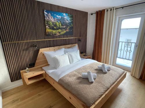 a bedroom with a bed with two towels on it at Alpenfels Zwieselstein in Sölden