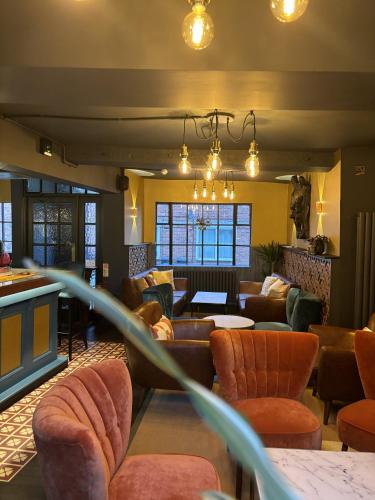 a lobby with couches and tables and chairs at Yak & Yeti in Shrewsbury