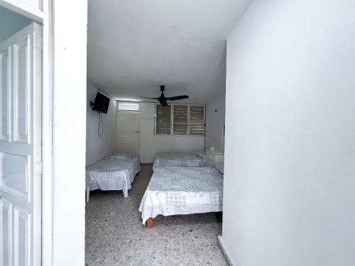 Ένα ή περισσότερα κρεβάτια σε δωμάτιο στο Hotel Walton