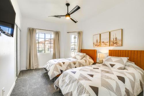 a bedroom with two beds and a ceiling fan at 2 Mi to Coachella Indio Oasis with Heated Pool in Indio